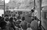 Krishna Seegopaul speaking, Counsellors Donald Witzel and Leonora Amstrong front row left, Rooplall Dudhnath on Leonora’s left, Bahá’í youth camp near Georgetown (12/75)