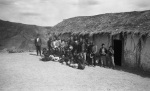 Villagers in front of the school in Jankarachi, Andrés Jachakollo center (taking off his hat), Francisco off to the left