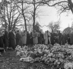 The Guardian's funeral, at grave after graveside service, Rúhíyyih Khánum (near center), 11/57