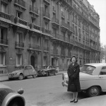 Joyce Dahl near the entrance to the Tobey Louvre show, 10/61