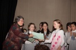 Mina receiving an award, February