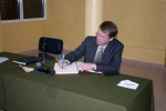 Greg signing the guest register after giving a talk at the national school for judges