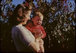 Joyce and Keith with apple in garden, 11/20/1941