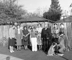 After the Feast of Ridván, probably at the Dahls' home in Palo Alto, California,  principal guests Emeric and Rosemary Sala. Emeric is kneeling right with Roger Dahl on his knee. Valerie Wilson center with striped dress.  4/21/1951